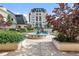 Beautiful condo complex with a calming water fountain surrounded by gorgeous landscaping and seating at 975 N Lincoln St # 3E, Denver, CO 80203