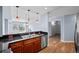 Well-appointed kitchen with stainless steel appliances, wood cabinets, and modern lighting at 975 N Lincoln St # 3E, Denver, CO 80203