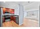 Stylish kitchen featuring stainless steel appliances, wood cabinets, and open to the living area at 975 N Lincoln St # 3E, Denver, CO 80203