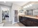 Bright bathroom featuring a double vanity, neutral walls, and an accessible walk-in closet at 22391 E Plymouth Cir, Aurora, CO 80016