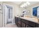 Bright bathroom with dual vanity sinks, dark wood cabinets, and a shower and tub combo at 22391 E Plymouth Cir, Aurora, CO 80016
