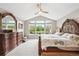 Bright bedroom showcases a detailed bed frame, vaulted ceilings and nature view at 22391 E Plymouth Cir, Aurora, CO 80016