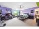 Colorful bedroom with purple walls, carpet, modern furniture, and a window with natural light at 22391 E Plymouth Cir, Aurora, CO 80016