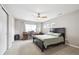 Spacious bedroom featuring a ceiling fan, carpeted floors, and a work space by the window at 22391 E Plymouth Cir, Aurora, CO 80016
