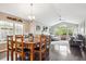 Dining area featuring a modern light fixture, large window and wood dining table at 22391 E Plymouth Cir, Aurora, CO 80016