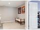 Hallway featuring wall art, a sitting bench, neutral walls, carpet, and a white door at 22391 E Plymouth Cir, Aurora, CO 80016