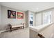 Hallway featuring wall art, a sitting bench, neutral walls, carpet, and a white door at 22391 E Plymouth Cir, Aurora, CO 80016