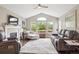 Comfortable living room boasts a fireplace, large windows and neutral decor at 22391 E Plymouth Cir, Aurora, CO 80016