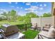 Outdoor patio with artificial grass, plush seating, and a stainless steel gas grill at 22391 E Plymouth Cir, Aurora, CO 80016