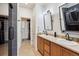Modern bathroom featuring dual sinks, ample counter space, and a walk-in closet at 16031 W 63Rd Ln # D, Arvada, CO 80403