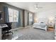 Bright bedroom with ample natural light, a ceiling fan, and a dedicated workspace at 16031 W 63Rd Ln # D, Arvada, CO 80403