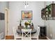 Cozy dining area featuring a round table, modern lighting, and stylish decor at 16031 W 63Rd Ln # D, Arvada, CO 80403