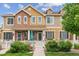 Charming two-story townhouse with brick accents, covered front porch, white picket fence and manicured landscaping at 16031 W 63Rd Ln # D, Arvada, CO 80403