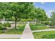 Green space with trees, grass, and sidewalks at 16031 W 63Rd Ln # D, Arvada, CO 80403