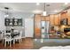 Modern kitchen and dining area with granite counters, stainless steel appliances, and stylish pendant lighting at 16031 W 63Rd Ln # D, Arvada, CO 80403