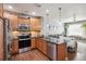 Modern kitchen with granite counters, stainless appliances, backsplash, and open to the living area at 16031 W 63Rd Ln # D, Arvada, CO 80403