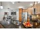 Open-concept kitchen with a large granite island, stainless steel appliances, and adjacent dining area at 16031 W 63Rd Ln # D, Arvada, CO 80403