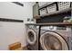 Modern laundry room with front-load washer and dryer, plus plenty of storage at 16031 W 63Rd Ln # D, Arvada, CO 80403