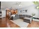Spacious living room with gray sofa, stylish rug, hardwood flooring, and open to the kitchen and dining area at 16031 W 63Rd Ln # D, Arvada, CO 80403