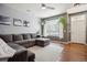 Bright living area with a large sectional sofa, hardwood floors, ceiling fan, and ample natural light at 16031 W 63Rd Ln # D, Arvada, CO 80403