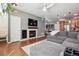 Cozy living room featuring a fireplace with stone surround, mounted TV, and open to the dining and kitchen areas at 16031 W 63Rd Ln # D, Arvada, CO 80403
