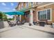 Front patio with umbrella, seating, and grill at 16031 W 63Rd Ln # D, Arvada, CO 80403