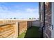 Backyard featuring artificial turf and a wooden fence, providing a private outdoor space at 4737 E Iliff Ave, Denver, CO 80222