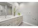 Bathroom with double sinks, large mirrors, and sleek vanity offers a clean and contemporary design at 4737 E Iliff Ave, Denver, CO 80222
