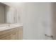 A well-lit half bathroom with a modern sink, vanity and a large mirror above it at 4737 E Iliff Ave, Denver, CO 80222