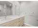 Bathroom featuring a double sink vanity with modern fixtures, framed by sleek mirrors and tile accents at 4737 E Iliff Ave, Denver, CO 80222