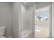 Modern bathroom featuring a walk-in shower with glass doors, complemented by sleek fixtures and neutral tones at 4737 E Iliff Ave, Denver, CO 80222