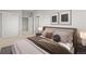 Comfortable bedroom with serene decor, including sliding closet doors and neutral-toned walls at 4737 E Iliff Ave, Denver, CO 80222