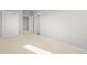 Bright bedroom featuring neutral carpet, light gray walls, a closet, and an open doorway at 4737 E Iliff Ave, Denver, CO 80222