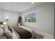 Tranquil bedroom with cozy bedding, large windows offering natural light and pleasant outdoor views at 4737 E Iliff Ave, Denver, CO 80222