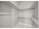 Walk-in closet with built-in shelves and chrome bars offers ample storage space at 4737 E Iliff Ave, Denver, CO 80222