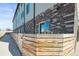 Low angle view showing the brick and siding of a residential building and partial fence at 4737 E Iliff Ave, Denver, CO 80222