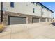 Row of garages with gray doors and stone accents at 4737 E Iliff Ave, Denver, CO 80222