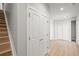 Hallway with new light wood flooring, gray walls, closet, stairs, and ample space at 4737 E Iliff Ave, Denver, CO 80222