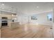 Spacious open-concept living area with modern kitchen, island, and sleek wood flooring at 4737 E Iliff Ave, Denver, CO 80222