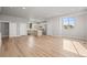 Bright, open living space with modern kitchen featuring stainless steel appliances and hardwood floors at 4737 E Iliff Ave, Denver, CO 80222