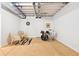 A basement area is staged with chairs, a rug, a dartboard, and a drumset at 8552 W San Juan Ave, Littleton, CO 80128