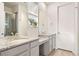 Elegant bathroom with granite countertops, dual sinks, tile floors, and shower with glass door at 8552 W San Juan Ave, Littleton, CO 80128