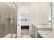 Modern bathroom with tiled shower, granite counters, and a vanity with a view into the bedroom at 8552 W San Juan Ave, Littleton, CO 80128