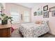 Cozy bedroom featuring floral bedding, natural light from the windows, and colorful wall art at 8552 W San Juan Ave, Littleton, CO 80128