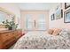 Bright bedroom with floral patterned bedding, soft pastel wall colors, and ample natural light at 8552 W San Juan Ave, Littleton, CO 80128
