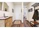 Inviting entryway with hardwood floors, stylish furnishings, and a view into the bedroom at 8552 W San Juan Ave, Littleton, CO 80128