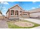 Charming home featuring a well-maintained lawn, inviting porch, and attached garage at 8552 W San Juan Ave, Littleton, CO 80128