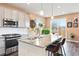Modern kitchen with granite countertops, stainless appliances, and open access to a dining area at 8552 W San Juan Ave, Littleton, CO 80128