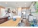 Open kitchen with stainless steel appliances, white cabinets, pendant lighting, island, and breakfast bar at 8552 W San Juan Ave, Littleton, CO 80128