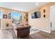 Cozy living room with a large window, hardwood floors, and stylish decor at 8552 W San Juan Ave, Littleton, CO 80128